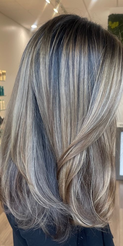 Cool ash blonde highlights on sleek long layers